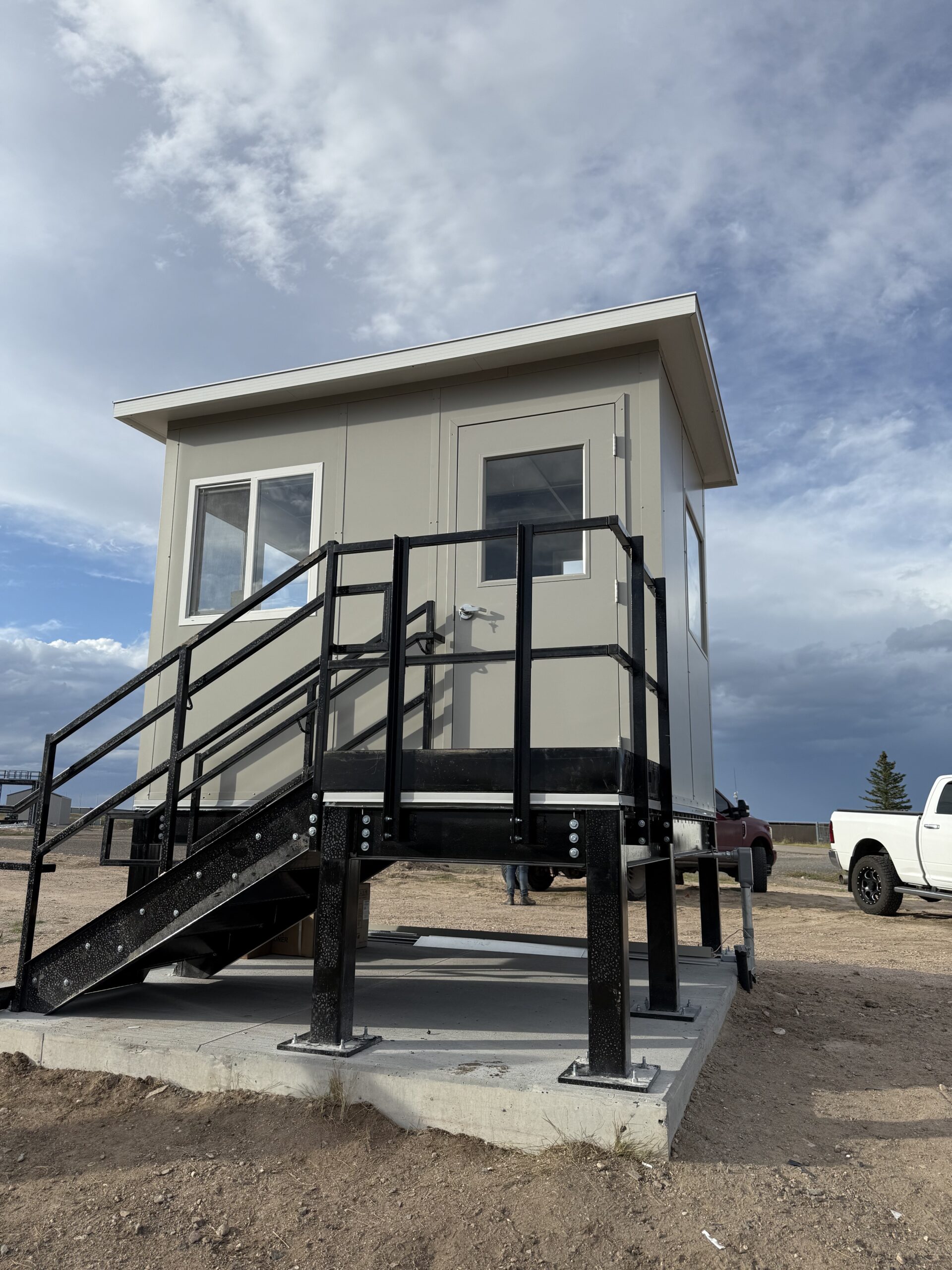 Elevated site security building on custom steel platform with stairs