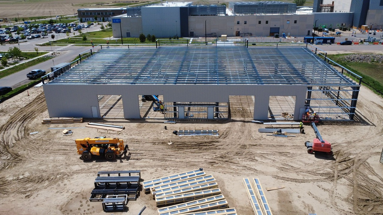 Ironworker installing roof purlins and panels