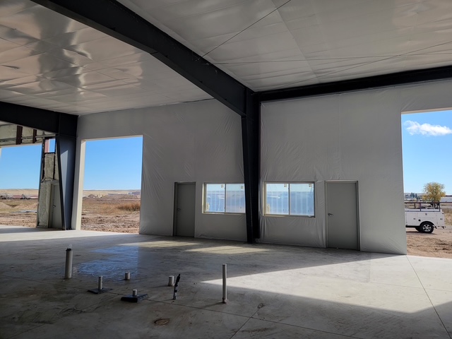 Finished barndominium interior with large windows